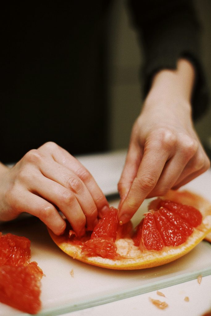 Grapefruit, Avocado, Dry Jack, and Wild Peppercorn Salad Grapefruit being segmented pexels